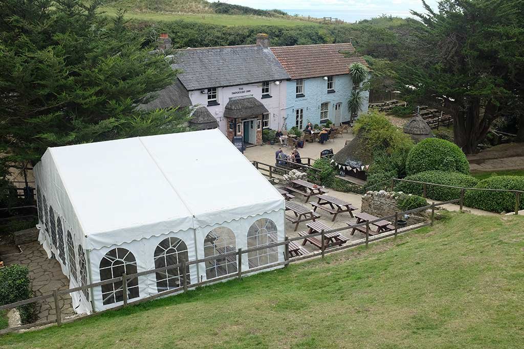 Another view of the pub with a marquee in the front beer garden