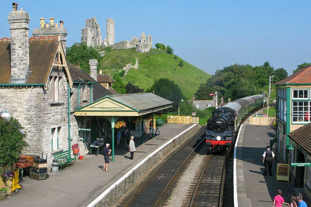 Corfe Castle Railway Station with Corfe Castle in the background.