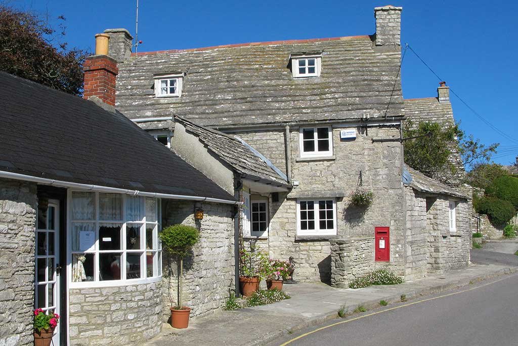 Stone cottages around the village green at Worth Matravers